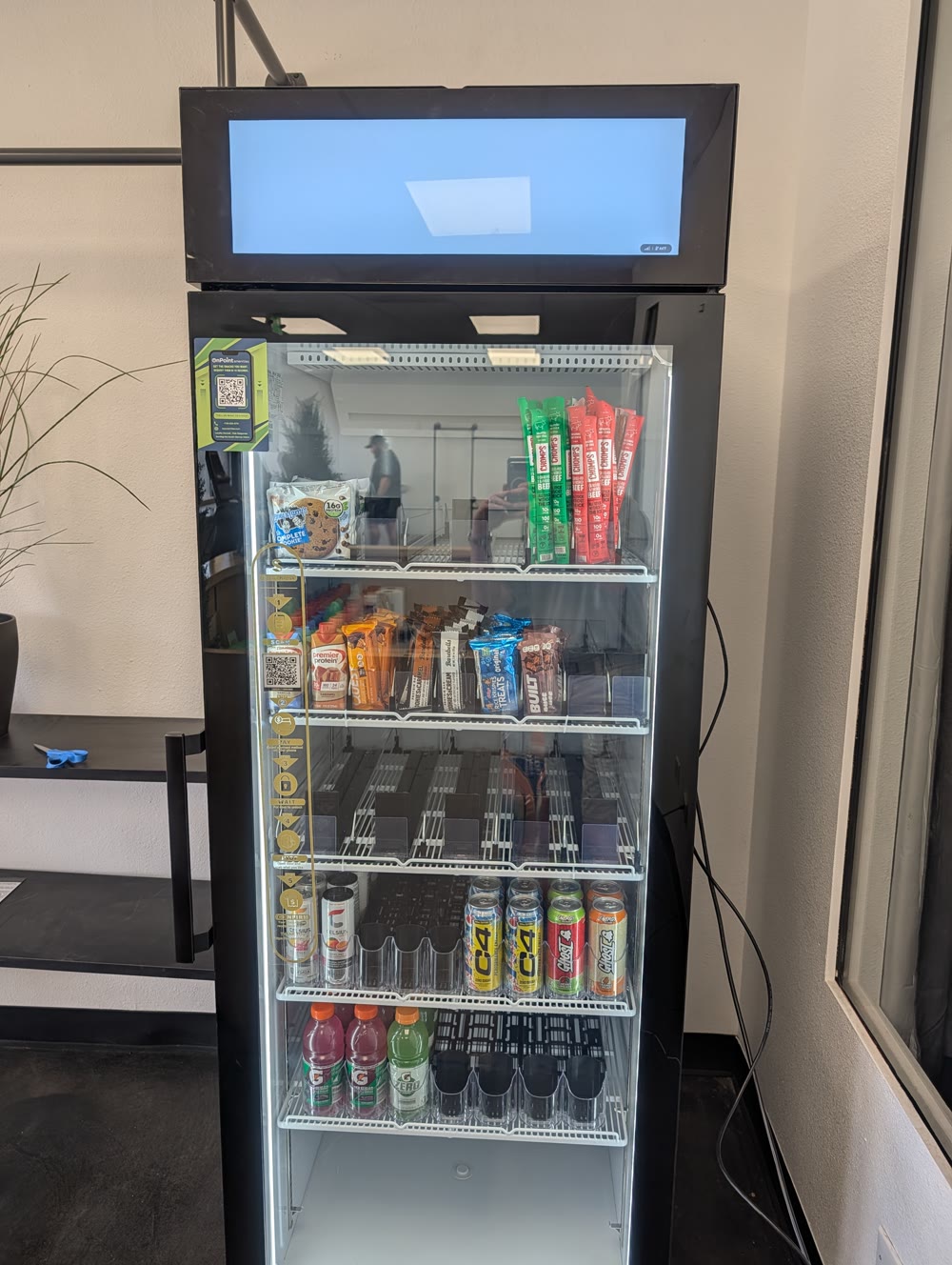 On Point smart cooler with digital header screen installed at a fitness center