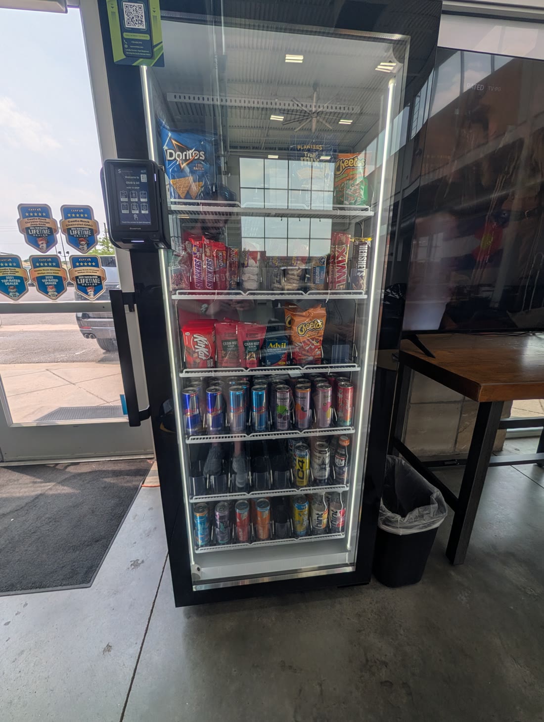 On Point smart cooler in the Castle Rock Autoplex GMC showroom beside the dealership's Top-Rated Dealer awards