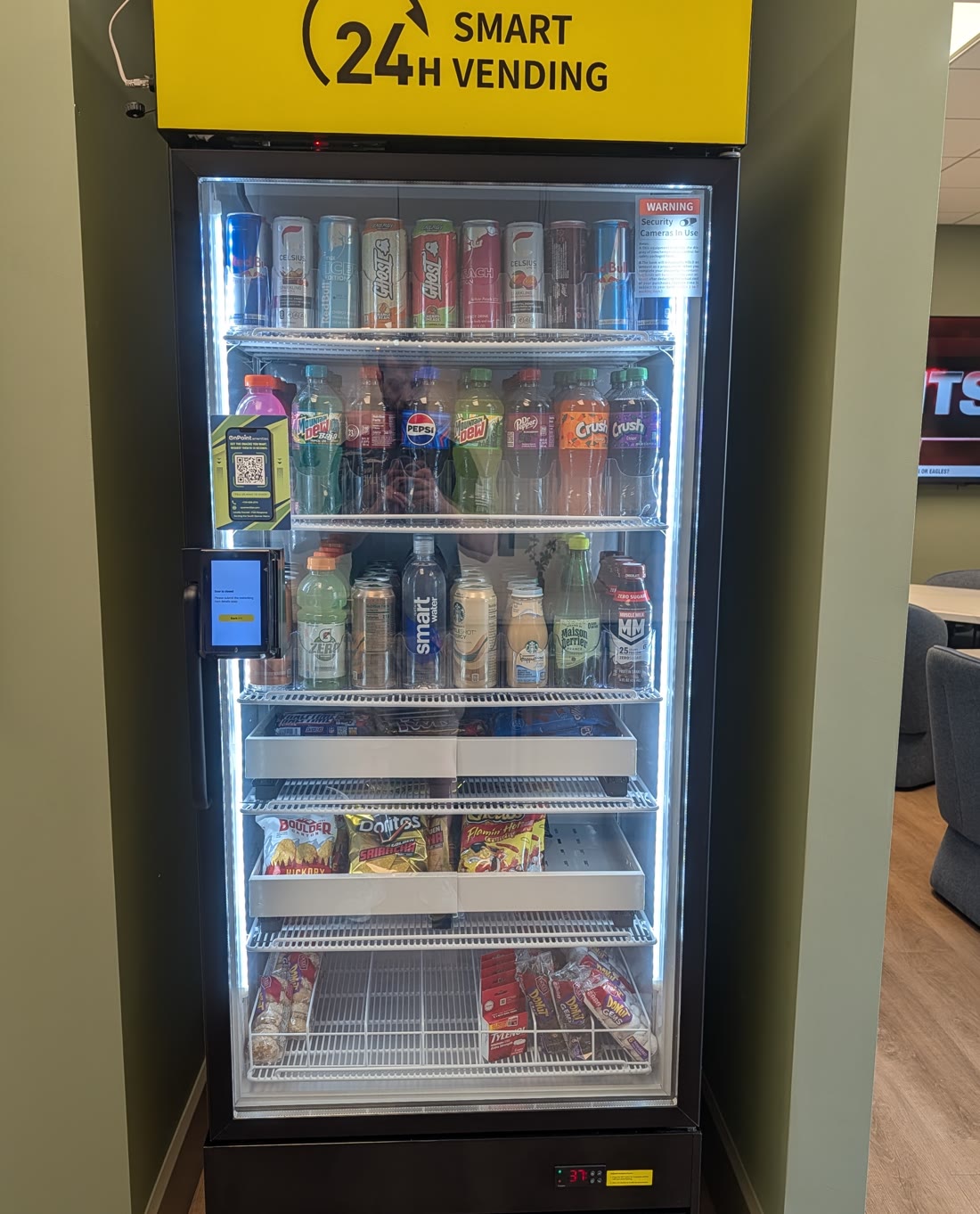 An On Point Amenities smart cooler, fully stocked, installed in a resident lounge